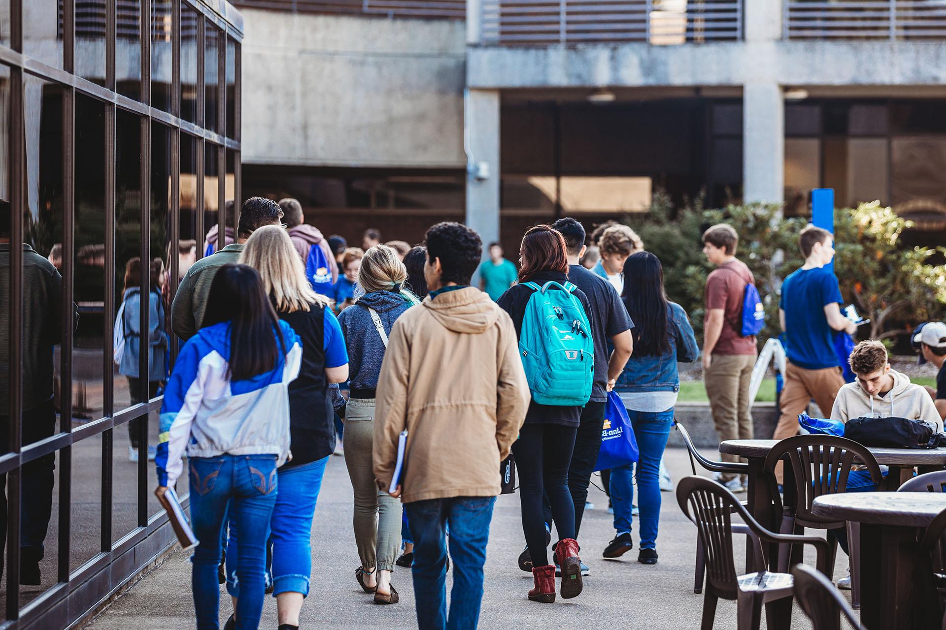 Students walking through the Albany Campus Courtyard between classes